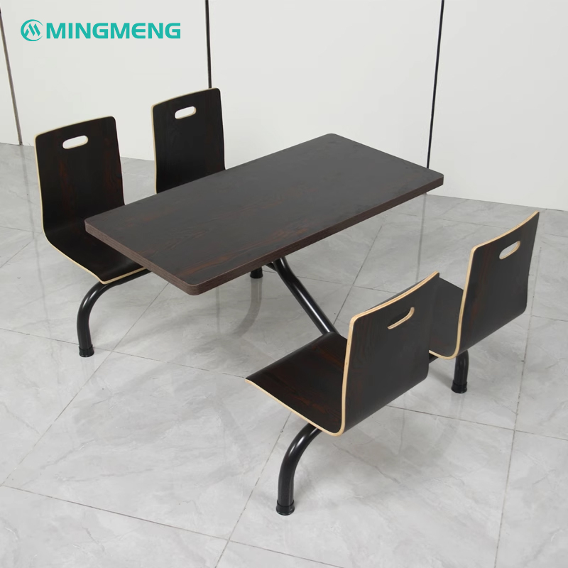 Four-person fixed dining table and chair unit with dark wood laminated finish, built for institutional cafeterias and factory canteens