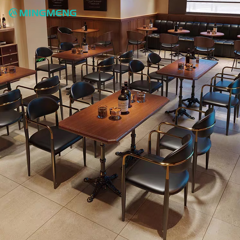 Dining chairs with black leather and gold arms in a restaurant environment