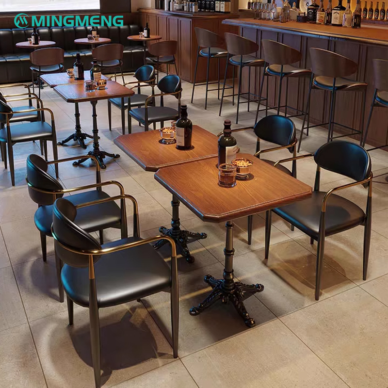 Multiple black leather armchairs with gold accents in a stylish café setup