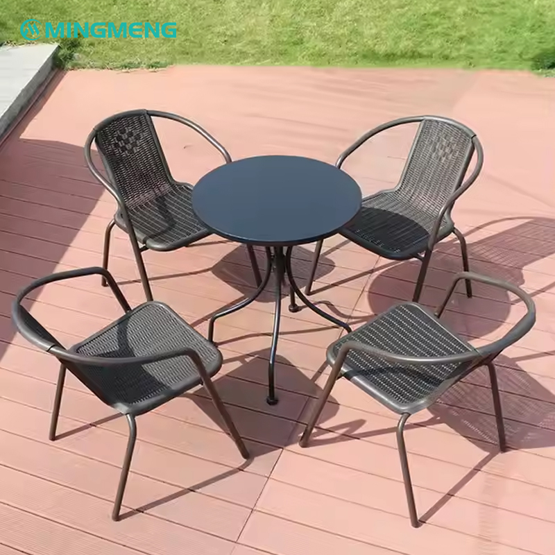 Black metal frame outdoor dining chairs with mesh seat and backrest arranged around a round patio table.