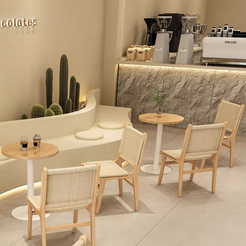 Woven Rope Wood Dining Side Chair2 Stylish cafe setup with rattan chairs around round wooden tables, creating a welcoming ambiance