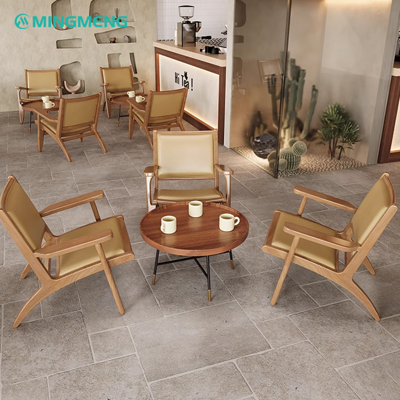 Cafe seating area with round coffee table and armchairs