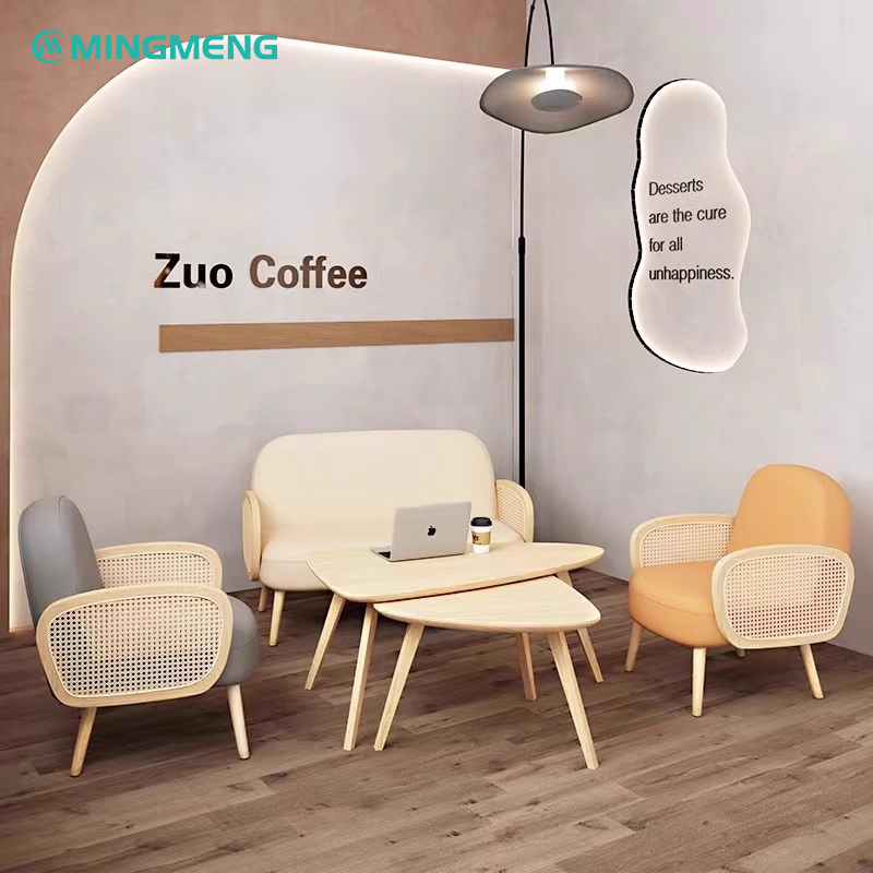 Stylish coffee shop restaurant booth with modern wooden tables and rattan chairs, offering a comfortable dining setting.