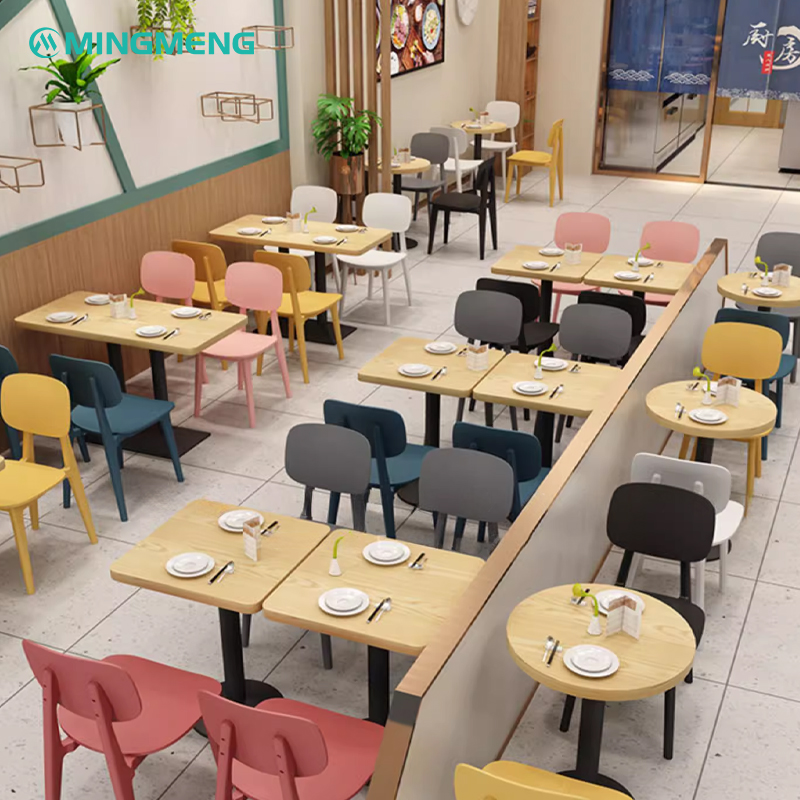 Restaurant dining area with pastel-colored plastic chairs in Nordic style paired with wooden tables set for meals