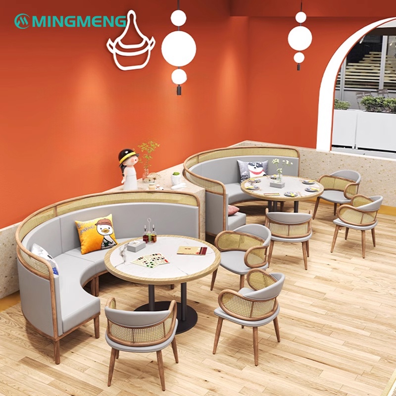 Curved rattan backrest dining booth layout against orange wall for modern café