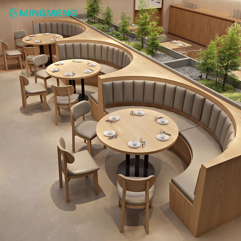 Modern curved restaurant booth seating with green vinyl padding and wood base, ideal for creating a stylish dining atmosphere in cafes and restaurants.