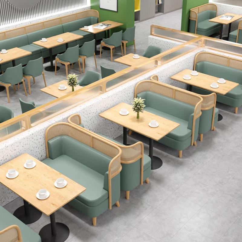 Green Faux Leather Restaurant Booth with Cane Backrest1 Spacious restaurant booth seating with green upholstery and wooden tables arranged for customers.