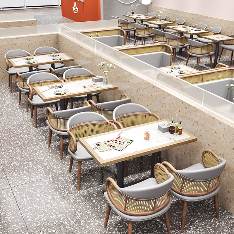 Vintage Rattan Backrest Leather Restaurant Booth Light grey booth seating paired with rattan dining chairs, organized in a spacious restaurant layout.