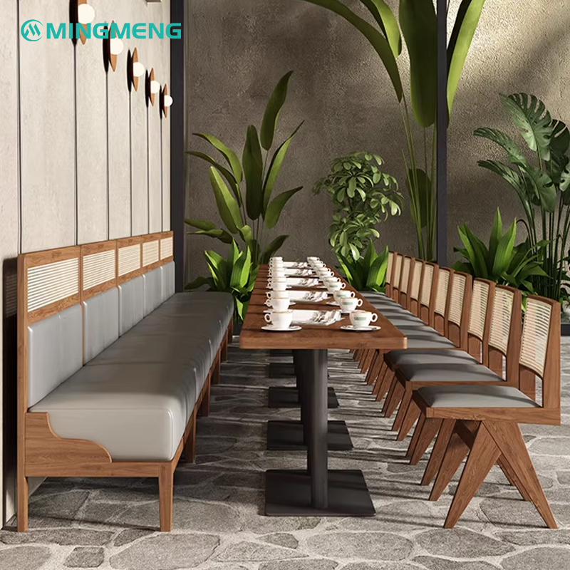 Two-seater booth with tan leather cushions and a wooden cane backrest, modern minimalist style