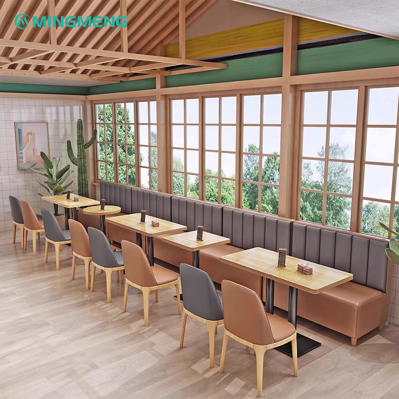 Continuous brown and gray leather booths against window wall in restaurant