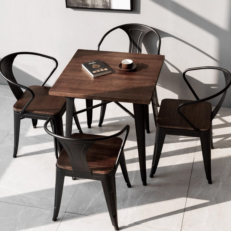 Black metal dining chair with curved backrest and dark wood seat for cafe or restaurant use