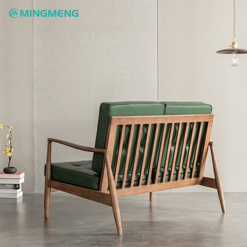 Mid-century modern green leather loveseat with solid wood frame, perfect for Nordic style dining room