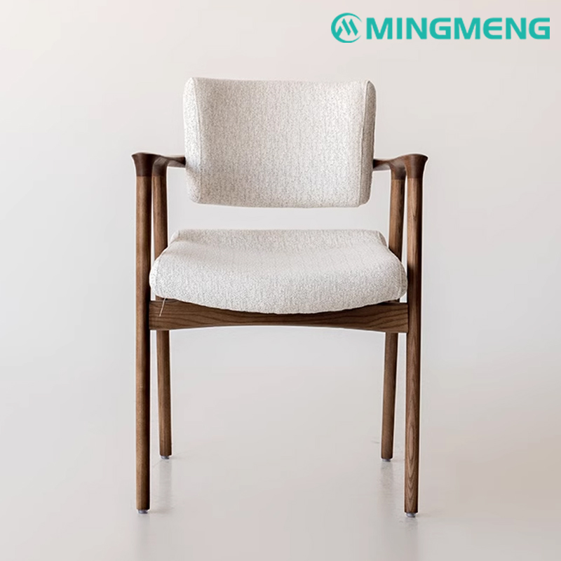 Front view of a dining chair featuring a cushioned fabric backrest and seat with a walnut wood structure