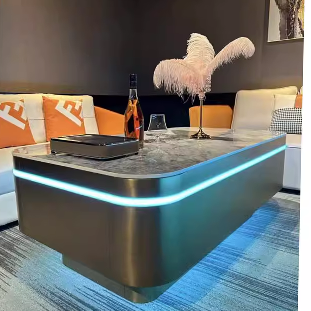Modern LED-lit stainless steel coffee table with marble top, paired with contemporary sofa seating