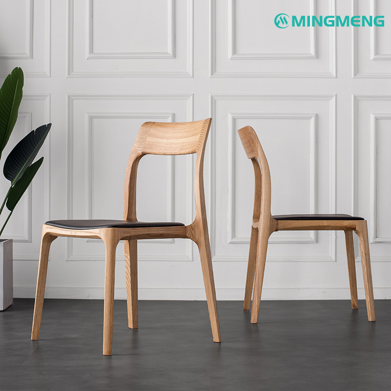 Light ash solid wood dining chair with ergonomic curved back and black leather seat