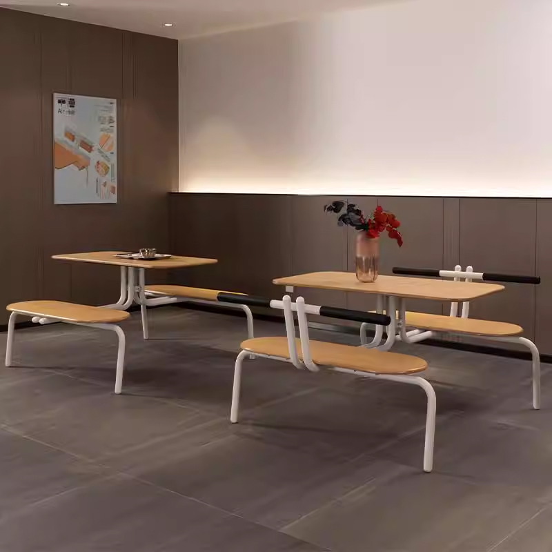 Modern 4-Seater Canteen Table and Bench Set Dining area with modern 4-seater canteen table and bench sets featuring light wood tops and white tubular frames, ideal for schools or corporate cafeterias