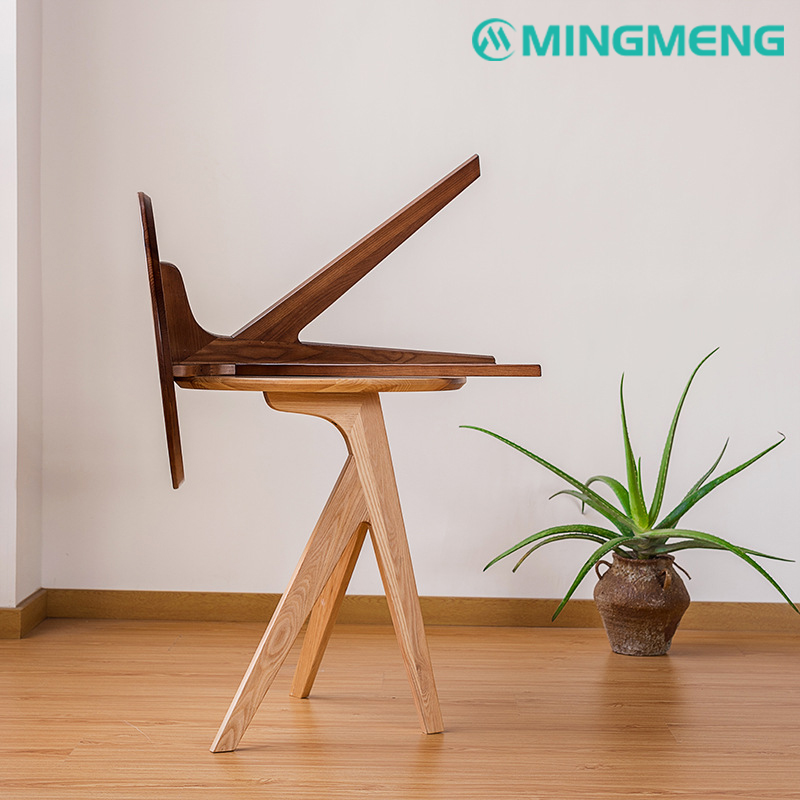 Side view of a modern Nordic wooden table with angled legs in a minimalist interior.