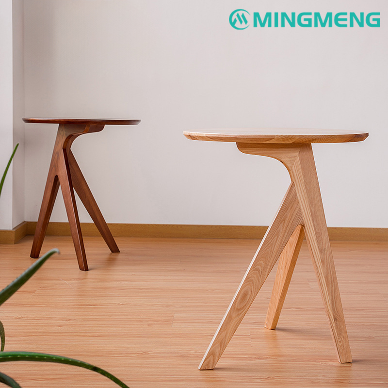 A sleek and stylish round wooden side table with triangular legs, perfect for small spaces or modern decor.