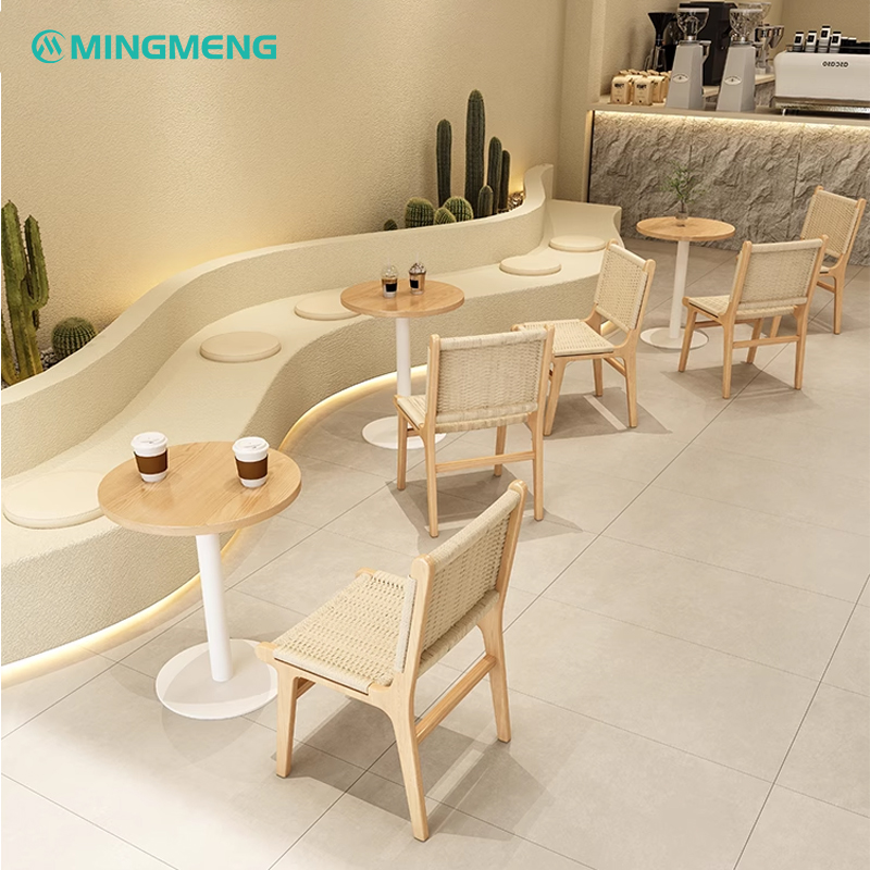 Modern cafe layout featuring rattan chairs and small wooden tables, offering a cozy atmosphere