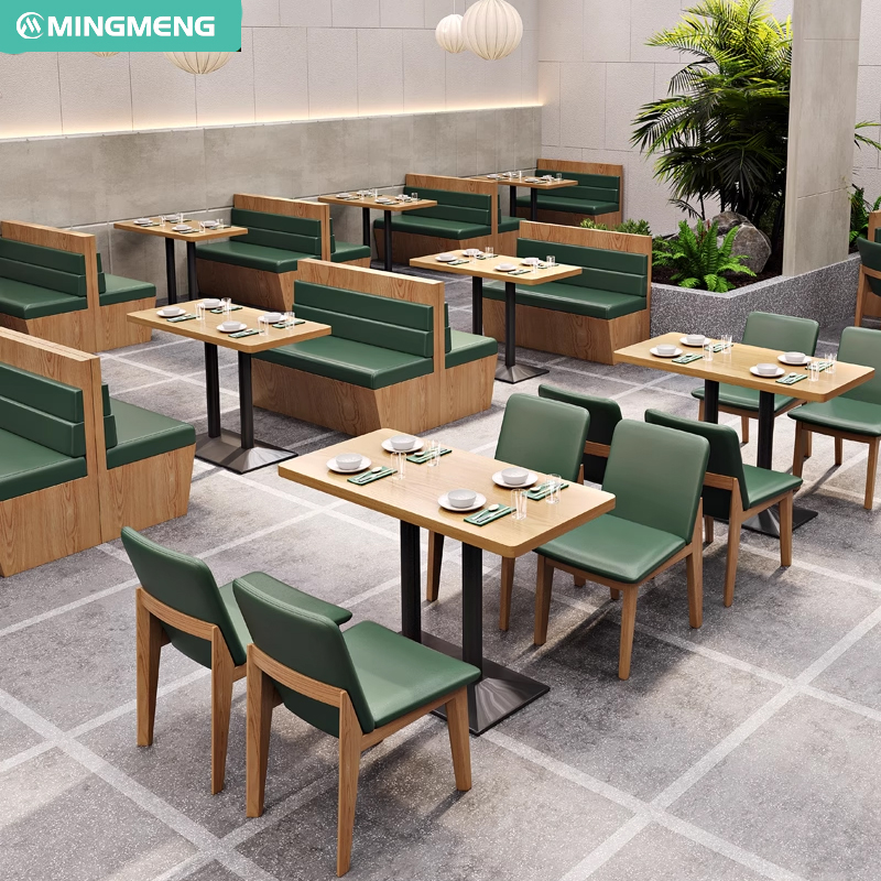Restaurant layout with green cushioned booth seating and matching chairs, modern and fresh interior