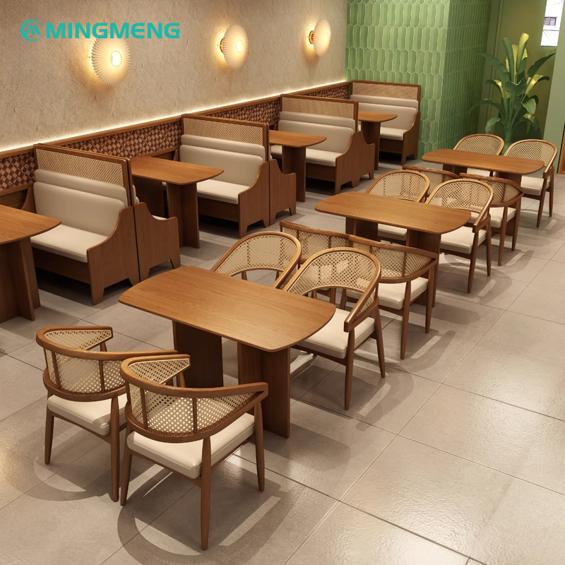 Combination of restaurant booths and rattan chairs with wooden tables in a tiled floor space