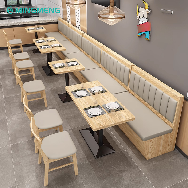 Restaurant booth seating with beige padded backrest and built-in storage, designed for both comfort and functionality in modern dining areas.