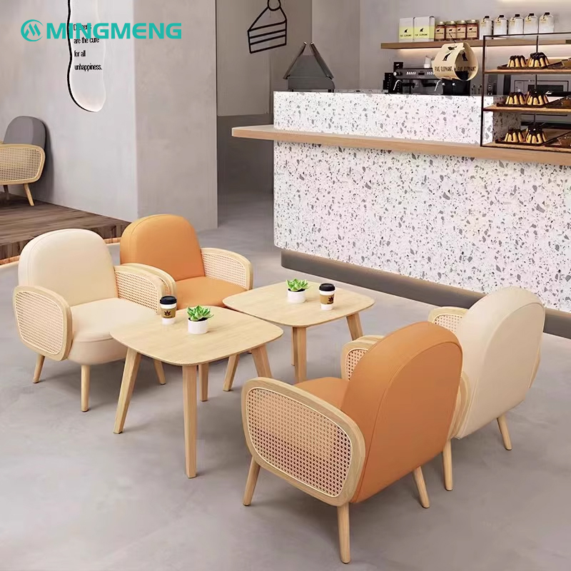 Modern restaurant booth featuring wooden tables and cream-colored chairs, designed for a cozy dining experience.