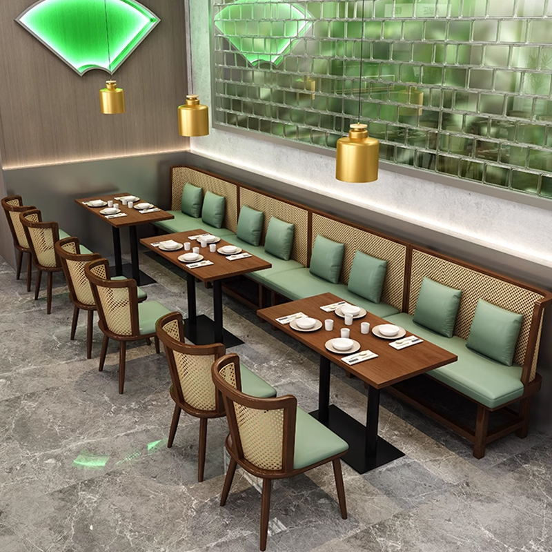Cane Back Wooden Booth Seating Cozy restaurant seating area with wooden tables, green cushions, and elegant chairs