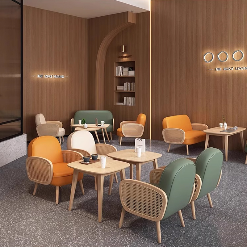 Cream-Colored Booth with Rattan Armrests Modern canteen furniture with light wood chairs and round tables in a spacious interior.