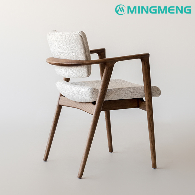 Scandinavian dining armchair with soft fabric seat and mid-century wood frame