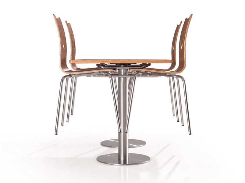 Smile Backrest Plywood Canteen Chair1 Neatly stacked smile back canteen chairs tucked under a rectangular table, showcasing space-saving design with chrome legs and curved plywood seats
