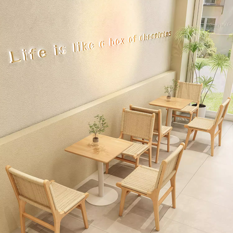 Woven Rope Wood Dining Side Chair Cafe seating with rattan chairs and small wooden tables, creating a minimalist and cozy setting