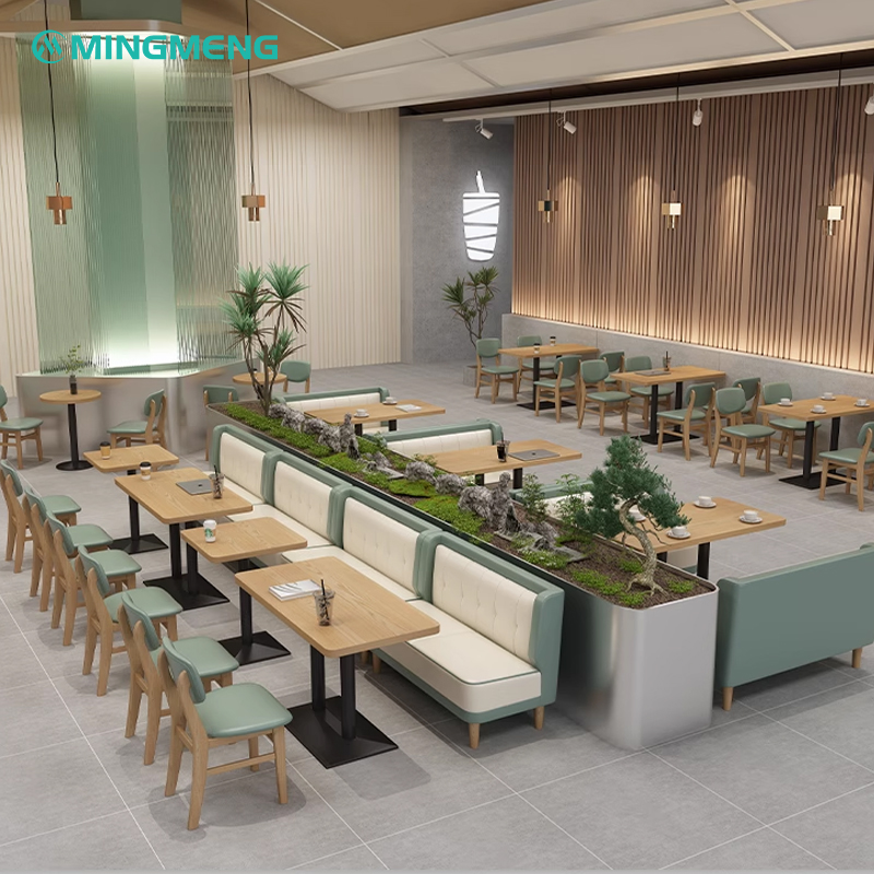 Cozy restaurant booth with wooden tables and green cushioned seating, perfect for dining areas.