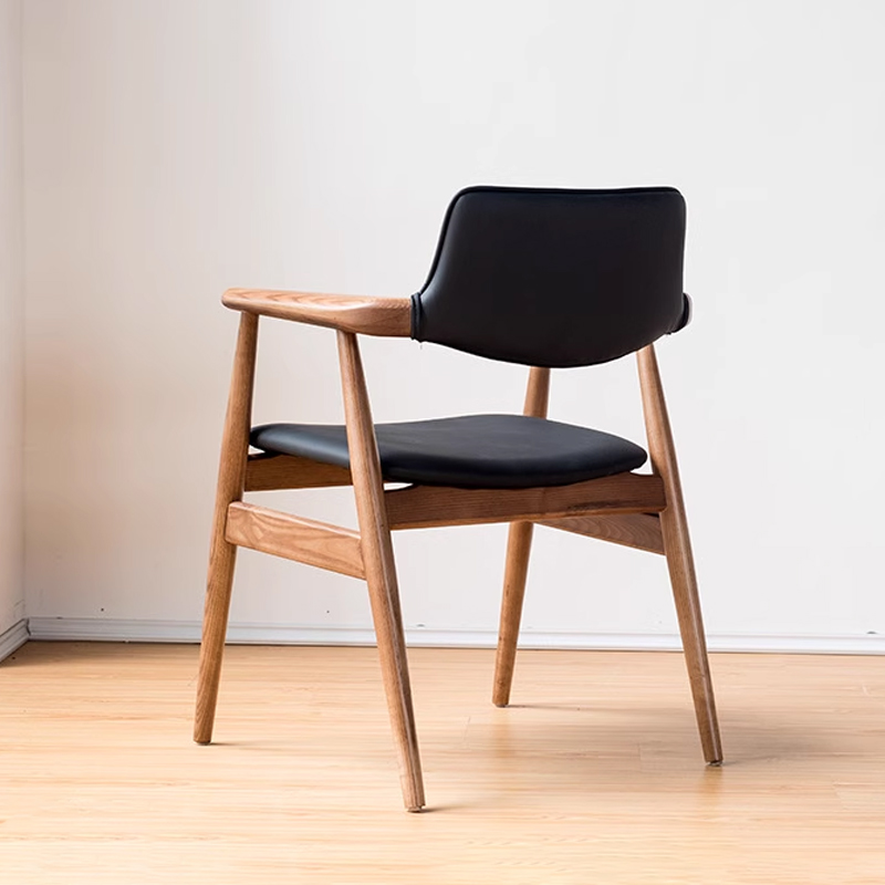 Scandinavian-style wooden armchair with curved arms and black leather back and seat for modern interiors