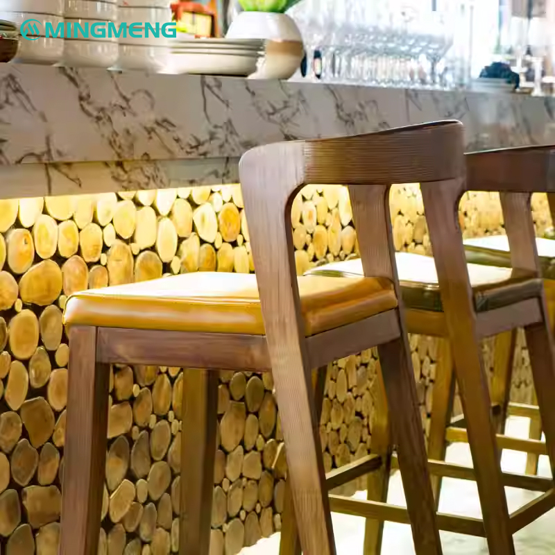 Wooden bar stool with yellow leather seat and backrest, placed in a modern interior setting.