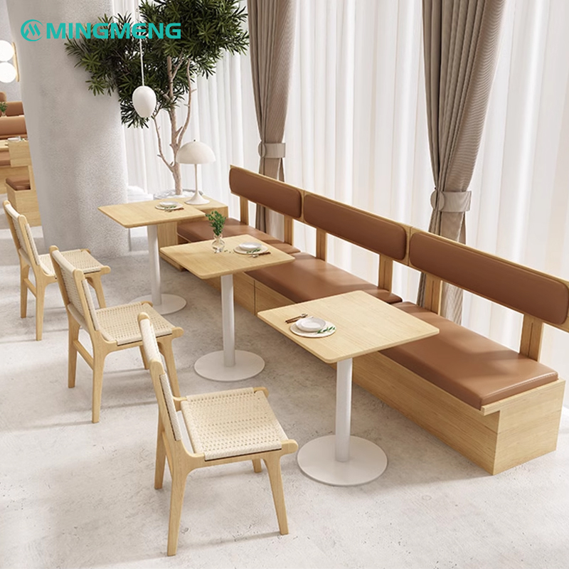 Modern dining setup with long wooden booth seating and beige woven dining chairs