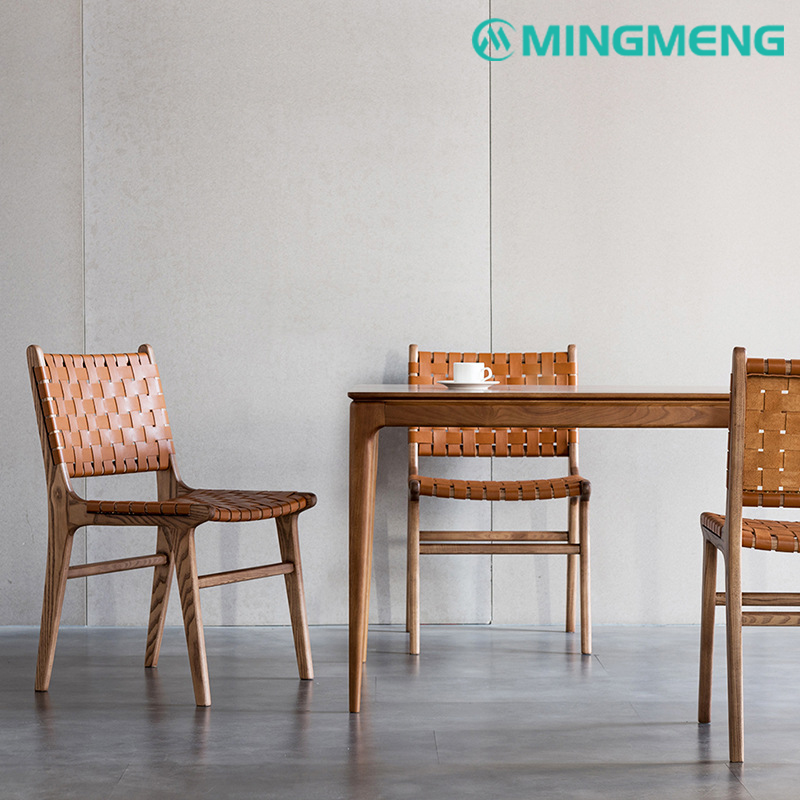 Side view of mid-century woven leather dining chair with solid wood frame