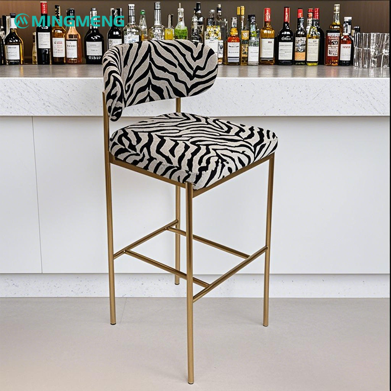 Stylish zebra print bar stool with gold frame for modern interiors