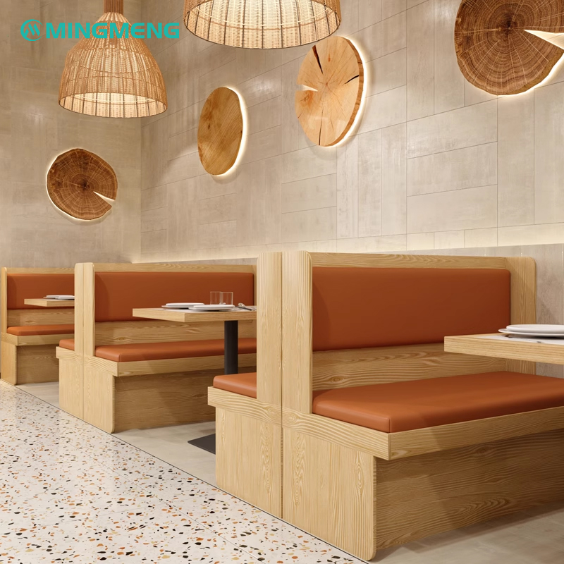 restaurant booth with light wood base and orange leather seat for two diners