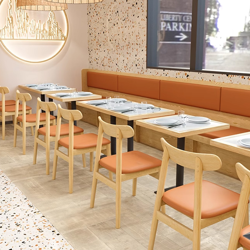 Modern Simple Cafe Benches Faux Leather Upholstered Booth1 long booth seating with orange upholstered backrest and natural wood base in a contemporary restaurant