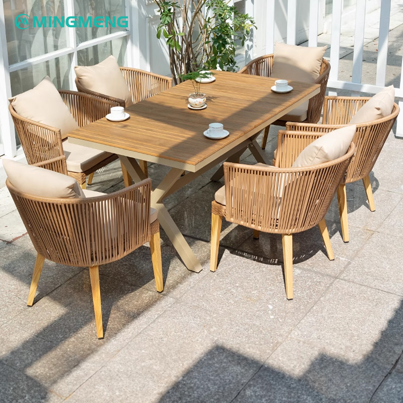 rattan armchairs around wooden outdoor table on balcony