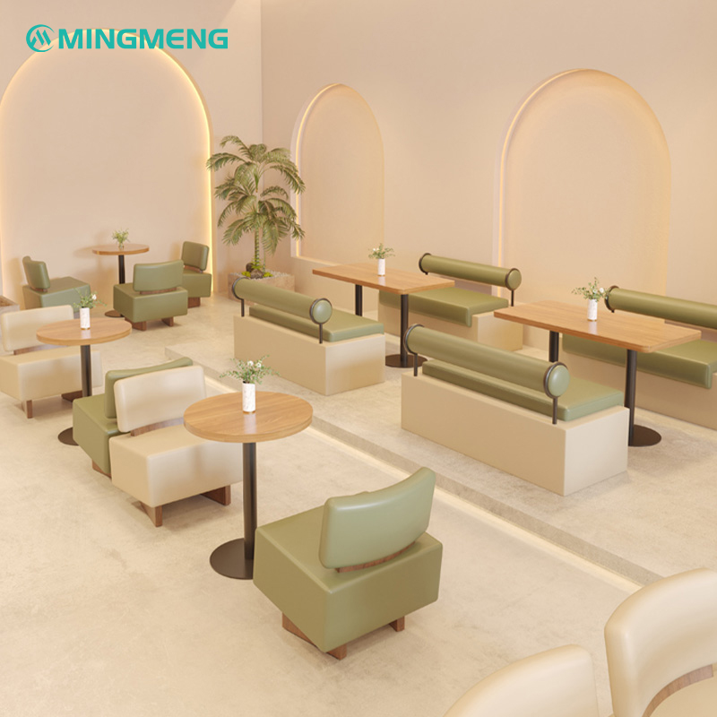 Cozy minimalist restaurant booth with green cushion and backrest, providing comfort in stylish cafes
