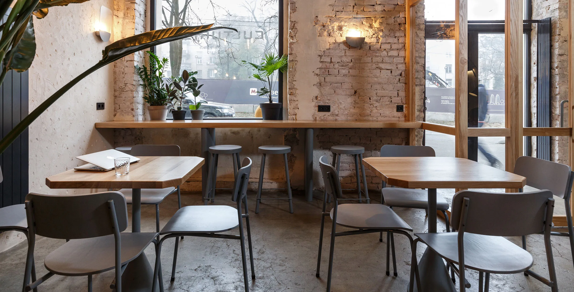Coffee table and chair set in a rustic café with wood tables and minimalist chairs