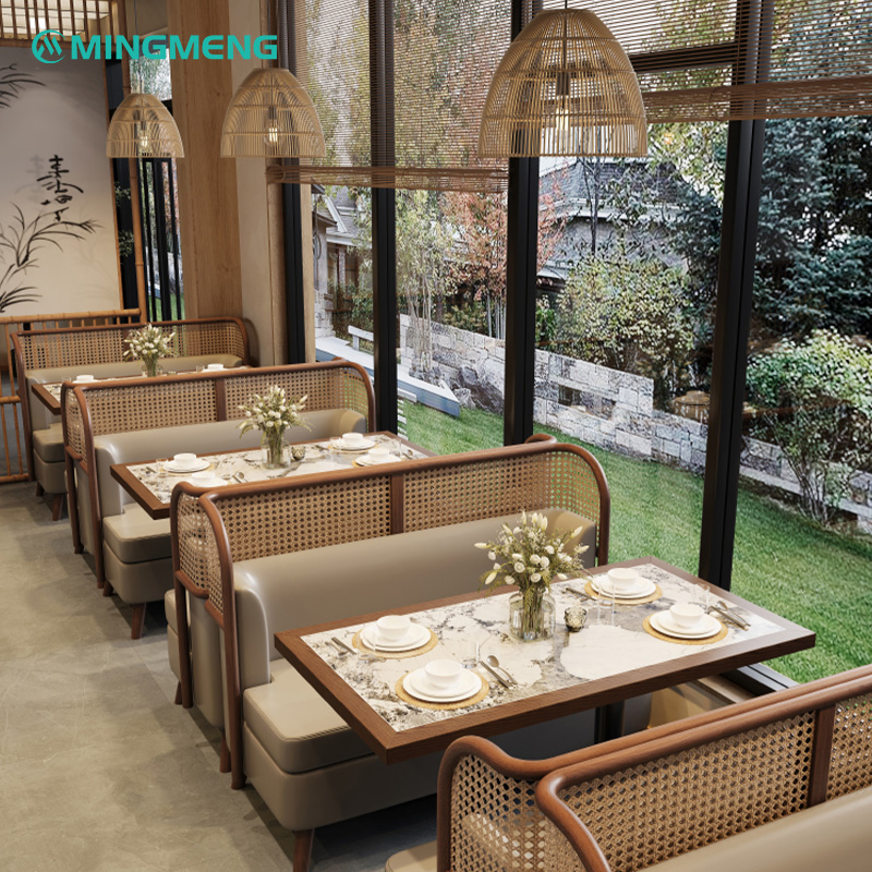 Custom Restaurant Booth – Dark Wood Frame with Beige Leather Seat & Rattan Backrest2 Stylish restaurant booth with cane backrest and marble dining table in a bright interior