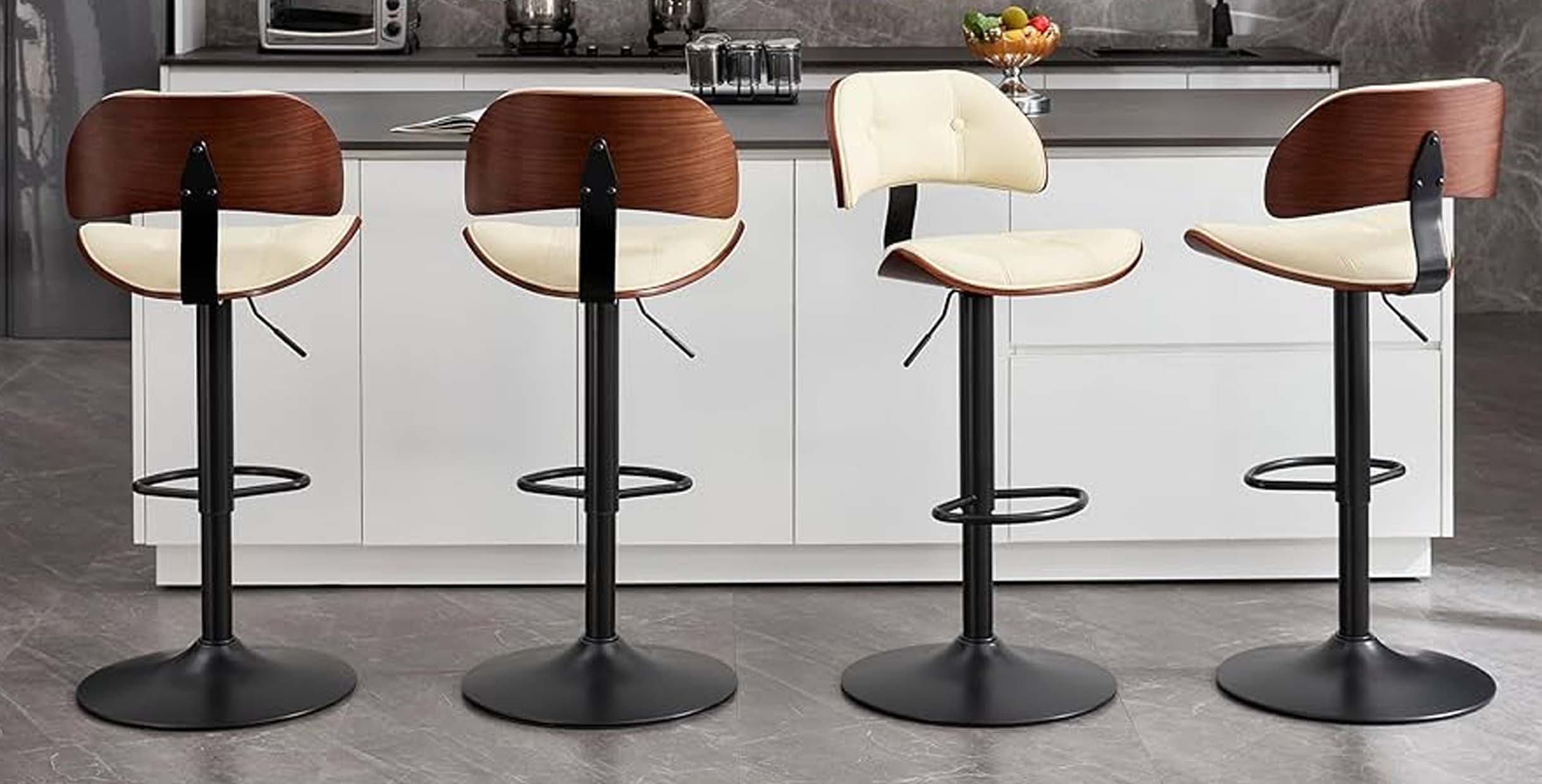 Set of modern bar stools featuring curved wood backrests, white cushioned seats, and black round pedestal bases.