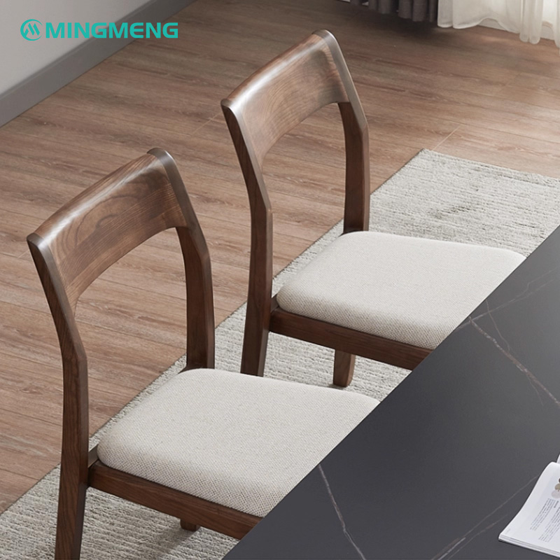 Dark Wood Frame with Grey Cotton-Linen Upholstered Restaurant Chair2 Pair of wooden dining chairs with curved backrest and light beige fabric upholstered seat placed beside a black dining table