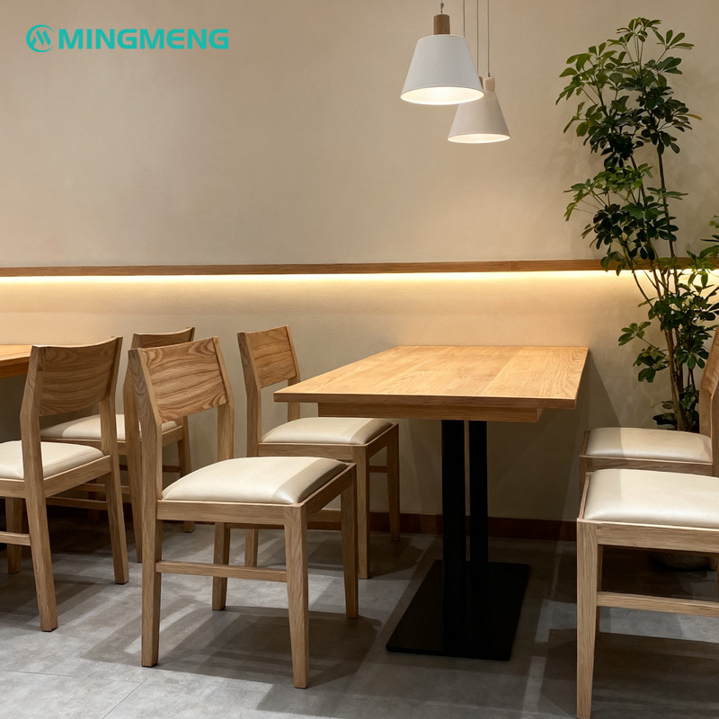 Nordic Solid Wood Restaurant Chair – Square Frame with White Leather Upholstered Seat3 Modern Nordic solid wood restaurant chairs with white leather upholstered seats around dining tables