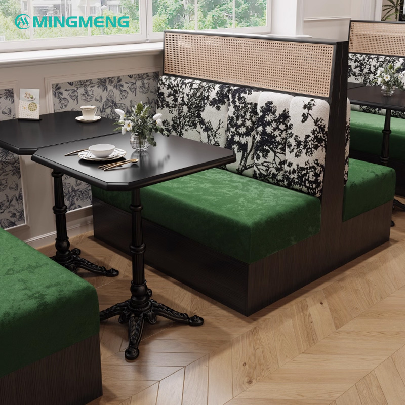 Artistic Restaurant Chair – Black Wood Frame with Green Velvet Seat & Patterned Backrest1 Restaurant booth with green upholstered seats, patterned backrest, and paired black dining tables