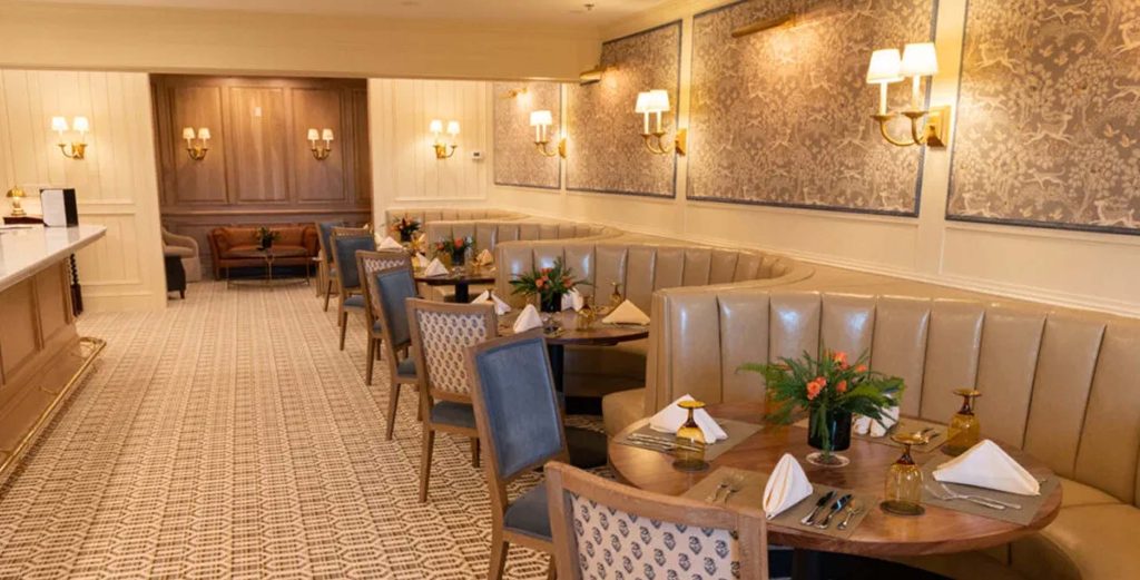 Elegant restaurant booth seating with wooden tables and soft lighting