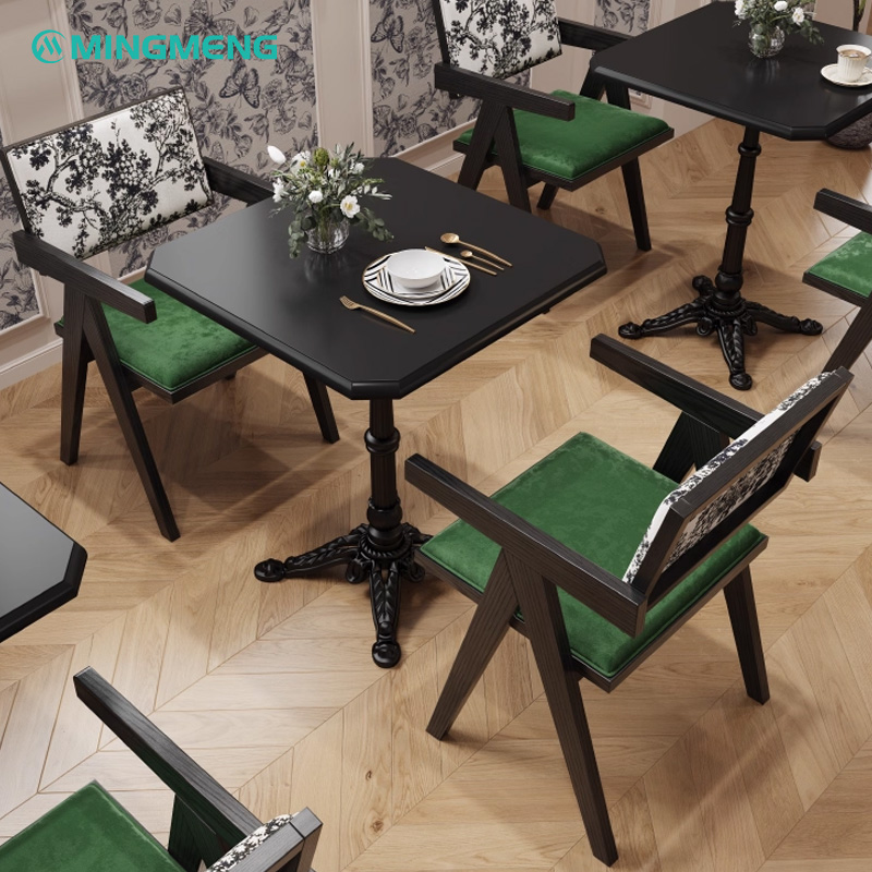 Artistic Restaurant Chair – Black Wood Frame with Green Velvet Seat & Patterned Backrest Restaurant dining set with dark wooden chairs featuring green cushions and patterned backrests, paired with black square dining tables